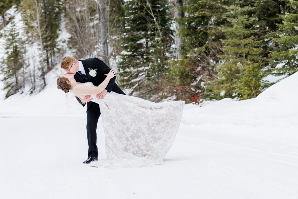 Wedding couple dance dip in the snow