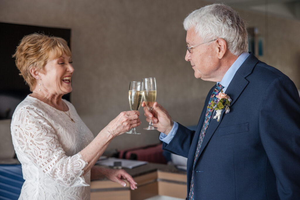 Bride and groom toasting with champagne.