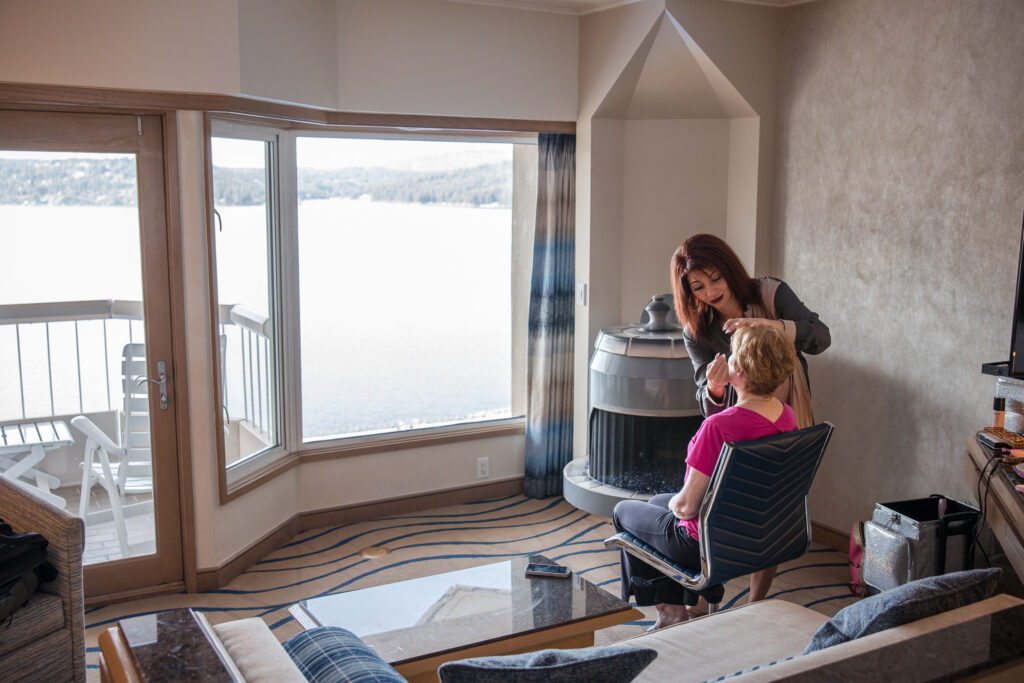 Bride getting makeup done in a lakeview suite at the Coeur d’Alene Resort