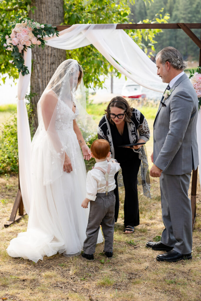 young boy hadning rings to officiant