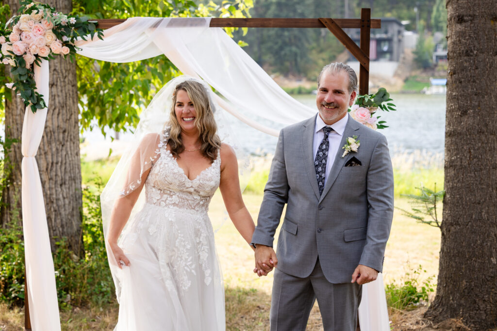 The bride and groom smile at their guest as they are announced as husband and wife.