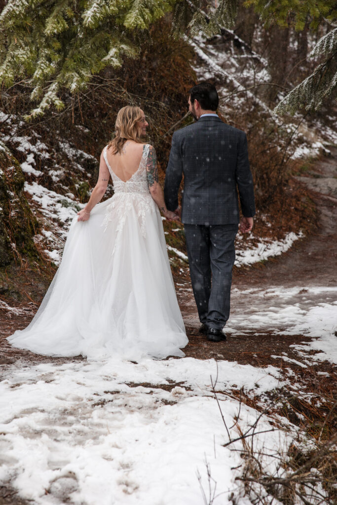 Bride and groom walking away hand in hand on Tubbs Hill