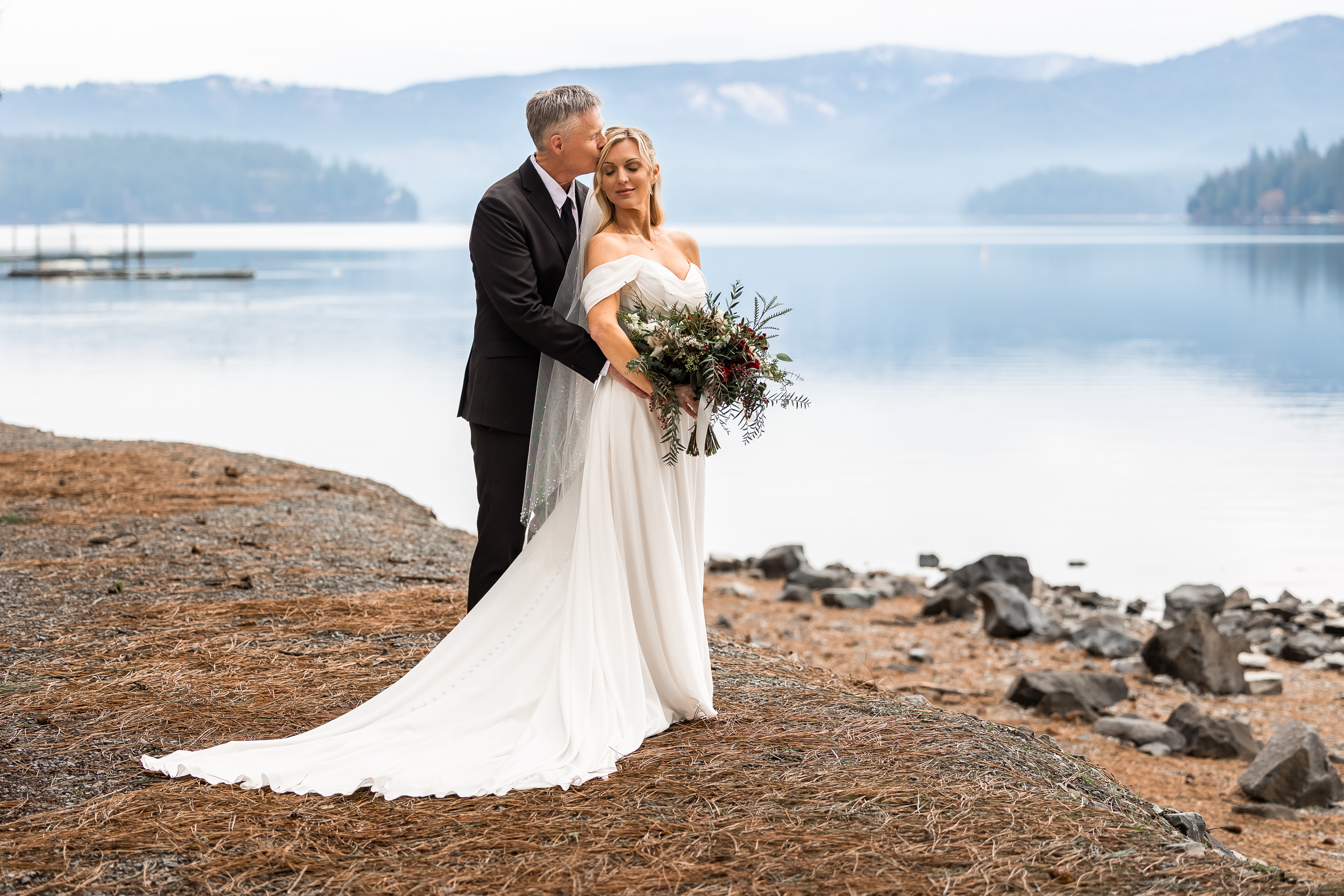 Couple eloping on shoreline of Hayden Lae