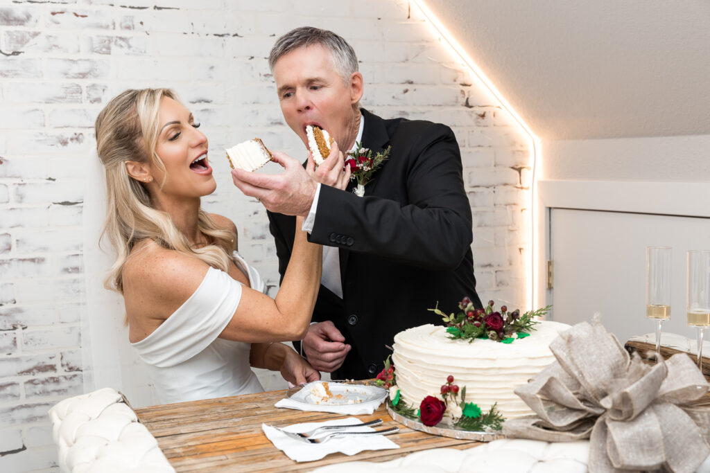 Brade and groom exchanging bites of their wedding cake